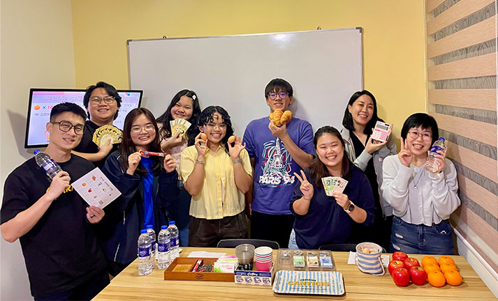 Students enjoy a non-traditional Korean language teaching activity, applying practical speaking skills in a classroom simulation to make learning fun.