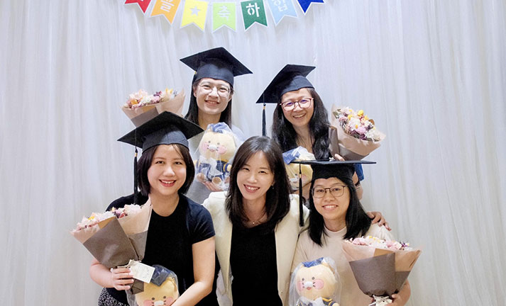 Graduated Master levels Korean language students with the school principal, celebrating in a friendly classroom environment ceremony after finishing the course.